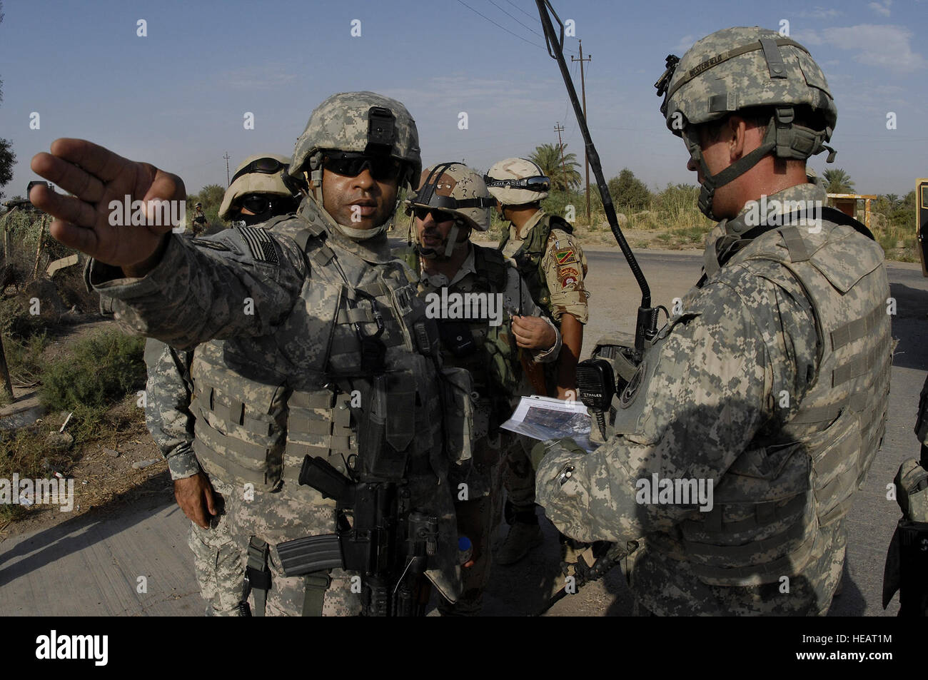 U.S. Army Soldiers, of the Alpha Company, 1st Battalion, 7th Cavalry Regiment, 1st Brigade Combat Team, 1st Cavalry Division, refer to a map during a mission in Taji, Iraq, Sept. 15. Stock Photo