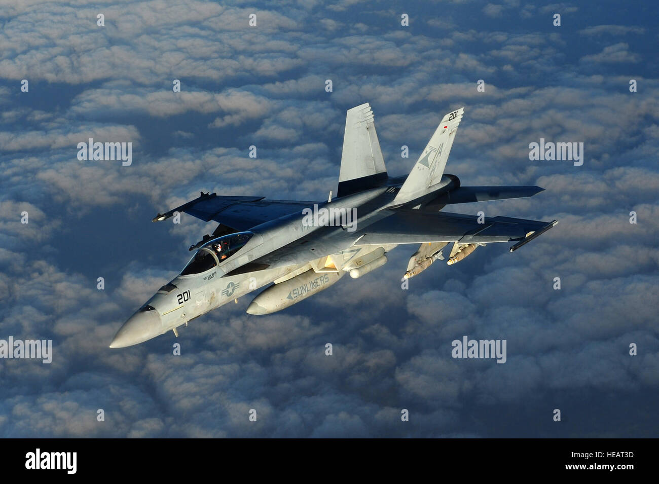 A Navy F/A-18 Super Hornet, assigned to the USS Carl Vinson, returns to its mission after being refueled by an Air Force KC-135 Stratotanker assigned to the 340th Expeditionary Air Refueling Squadron in the skies above Afghanistan in support of Operation Enduring Freedom, Mar. 2, 2011. Master Sgt. William Greer) Stock Photo