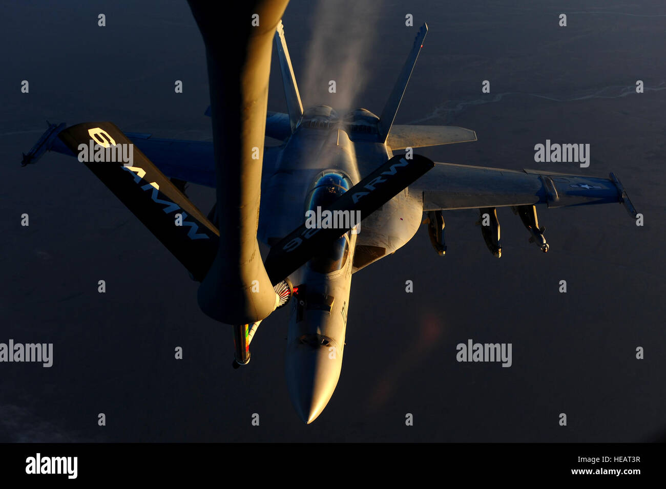 A Navy F/A-18 Super Hornet, assigned to the USS Carl Vinson, disconnects from the refueling boom of an Air Force KC-135 Stratotanker assigned to the 340th Expeditionary Air Refueling Squadron, in the skies above Afghanistan supporting Operation Enduring Freedom, Mar. 2, 2011. Master Sgt. William Greer) Stock Photo