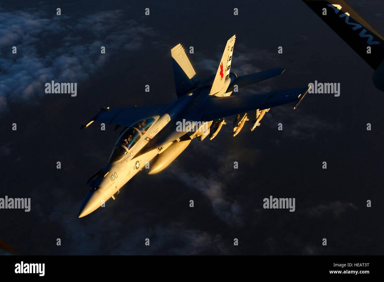 A Navy F/A-18 Super Hornet, assigned to the USS Carl Vinson, returns to its mission after being refueled by an Air Force KC-135 Stratotanker assigned to the 340th Expeditionary Air Refueling Squadron in the skies above Afghanistan in support of Operation Enduring Freedom, Mar. 2, 2011. Master Sgt. William Greer) Stock Photo