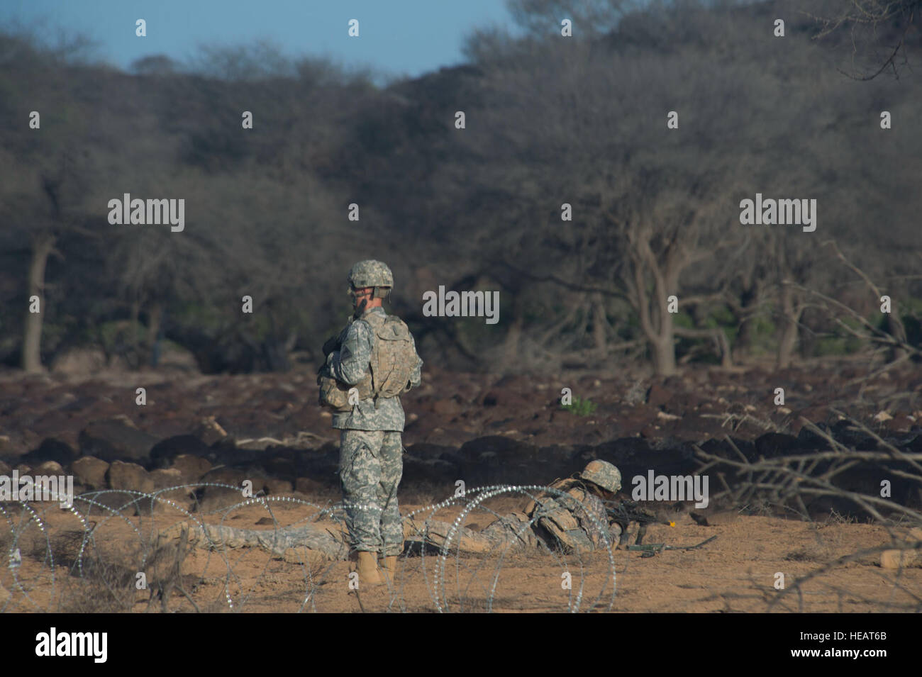 A Soldier from Alpha Company,1st Armored Battalion, 77th Armored Regiment 3rd Armored Brigade Combat Team, 1st Armored Division, East Africa Response Force (EARF) lays down supporting fire from the prone position while being evaluated during a live fire training exercise at the Arta training range in  Djibouti, May 30, 2015. The EARF is a quick reaction force designed to defend U.S. assets within the Combined Joint Task Force Horn of Africa area of responsibility. ( Staff Sgt. Gregory Brook/ Released) Stock Photo