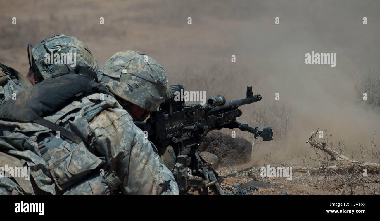 Soldiers from Alpha Company,1st Armored Battalion, 77th Armored Regiment 3rd Armored Brigade Combat Team, 1st Armored Division, East Africa Response Force (EARF) lays down suppressive fire as part of a supporting fire team using an M240 machine gun from the prone position during a live fire training exercise at the Arta training range in Djibouti, May 30, 2015.  The EARF is a quick reaction force designed to defend U.S. assets within the Combined Joint Task Force Horn of Africa area of responsibility. This photo has been cropped to emphasize the subject. ( Staff Sgt. Gregory Brook/ Released) Stock Photo