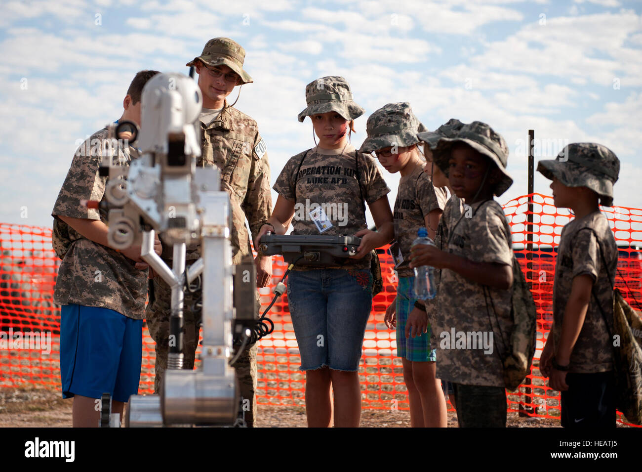 Brianna Sutton, age 10, daughter of Tech. Sgt Stanley Sutton, 56th Logistics Readiness Squadron, controls a explosive ordnance disposal robot during the sixth annual Operation Kids event at Luke Air Force Base, Ariz., Oct. 25, 2014. Operation Kids is a simulated deployed exercise for kids to help them understand the things their parents do when preparing for a deployment and what it’s like to be in a deployed environment.  Staff. Sgt. Staci Miller) Stock Photo