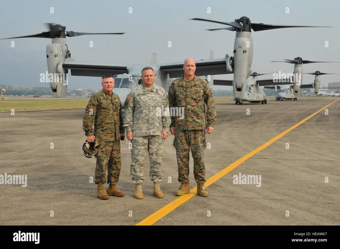 From left to right: U.S. Marine Lt. Gen. Terry Robling, U.S. Army Lt. Gen. Francis Wiercinski and U.S. Marine Maj. Gen. Christopher Owens pose in front of three U.S. Marine Corps MV-22B Ospreys Feb. 21 prior to boarding the aircraft at Wing 41 Royal Thai Air Force Base in Chiang Mai province, Kingdom of Thailand. The aircraft transported  the general officers to Ban Dan Lan Hoi, Sukothai province, to attend a combined arms live-fire exercise, the culminating event of exercise Cobra Gold 2013. As the largest multinational exercise in the Asia-Pacific region, CG 13 has demonstrated the commitmen Stock Photo