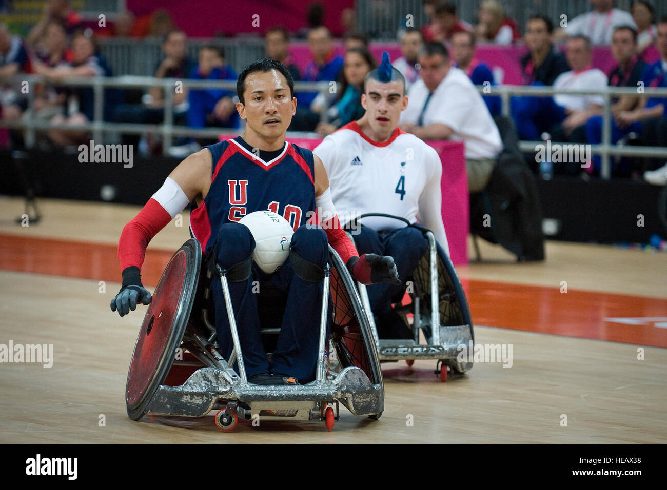 Retired U.S. Sailor William Groulx, left, the U.S. wheelchair rugby team captain, heads toward the goal to score a point against the Great Britain team during a match at the Paralympic Games in London Sept. 5, 2012. The Paralympics is a major international sporting event in which thousands of athletes, including wounded and injured U.S. Service members, participate in a variety of sporting events.  Master Sgt. Sean M. Worrell Stock Photo