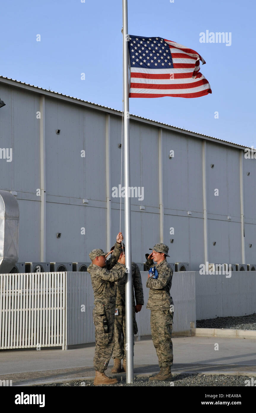 Firefighters from the 380th Expeditionary Civil Engineer Squadron Fire Department prepare to lower the American flag at the 380th Air Expeditionary Wing's 9-11 memorial at the end of the duty day at a non-disclosed base in Southwest Asia on May 29, 2010.  The memorial is a tribute to the men and women who died in the terrorist attacks in the United States on Sept. 11, 2001. The wing is home to the KC-10 Extender, U-2 Dragon Lady, E-3 Sentry and RQ-4 Global Hawk aircraft. The 380th AEW is comprised of four groups and 12 squadrons and the wing's deployed mission includes air refueling, air battl Stock Photo