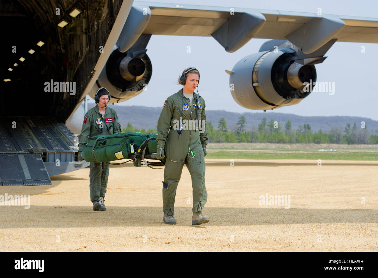 U.S. Air Force flight nurses and aeromedical technicians move medical