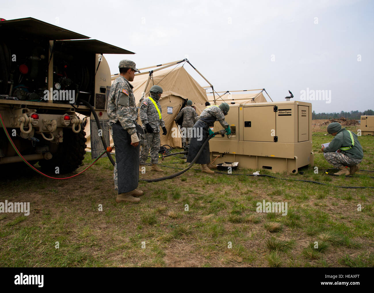 us-army-soldiers-fuel-up-a-generator-which-provides-heat-to-the-tents-HEAXFT.jpg