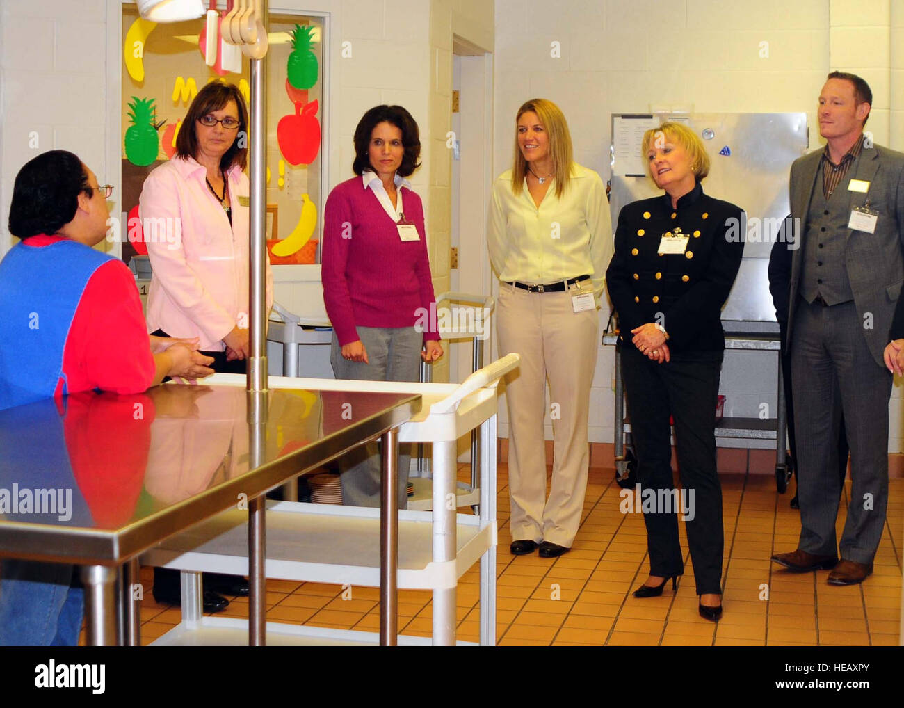 Melissa Delgado, a member of the Altus Air Force Base Child Development Center staff, briefs Laurie Salafia, CDC assistant chief, Leah Thomas, wife of 97th Air Mobility Wing commander, Maggie Elder, wife of the 97th AMW vice commander, Patty Solo, wife of 19th Air Force commander Maj. Gen. Mark Solo, and Anthony Raas, 97th Force Support Squadron, about how they prepare children's food at the CDC. During the tour, Solo was updated on the changes the CDC has undergone as well as the facility's accomplishments. Stock Photo
