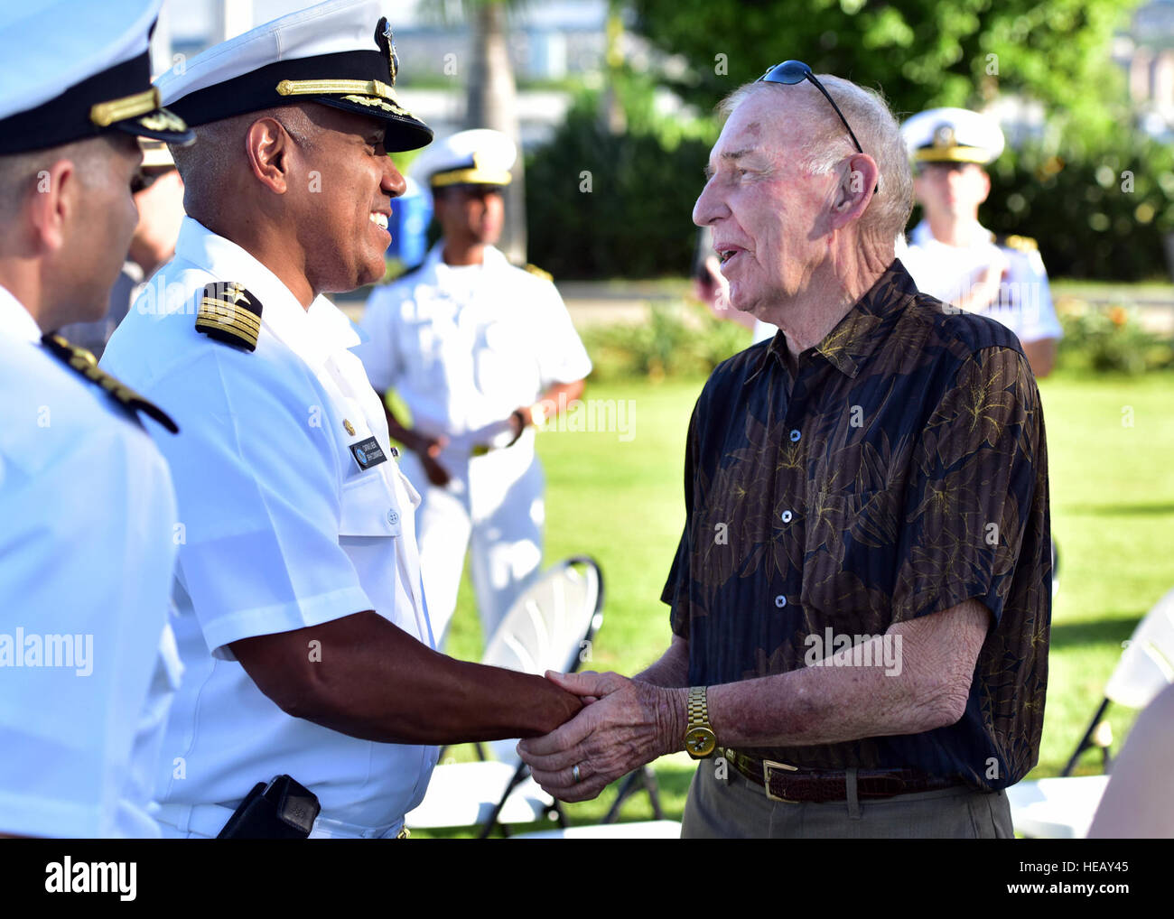 Capt. Stanley Keeve, commander of Joint Base Pearl Harbor-Hickam, and retired Navy Capt. Gerald L. Coffee, a former Vietnam War prisoner of war, exchange greetings after the Pearl Harbor Colors ceremony, held Thursday at the Pearl Harbor Visitor Center. The special ceremony paid homage to the service and sacrifices of those who were missing in action (MIA) and prisoners of war (POW). The Pearl Harbor Colors ceremony highlights a different theme of military heritage every month.  Senior Airman Christopher Stoltz) Stock Photo
