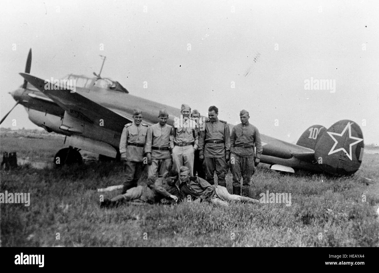 Russian pilots and ground crew stand in front of a YAK-4 bomber at Poltava, Russia, during the first shuttle raid -- Italy to Russia and return -- in June 1944. GI is TSgt. Bernard J. McGuire, Tonawanda, N.Y., of the 348th Bomb Squadron, 99th Bomb Group. (U.S. Air Force photo) Stock Photo