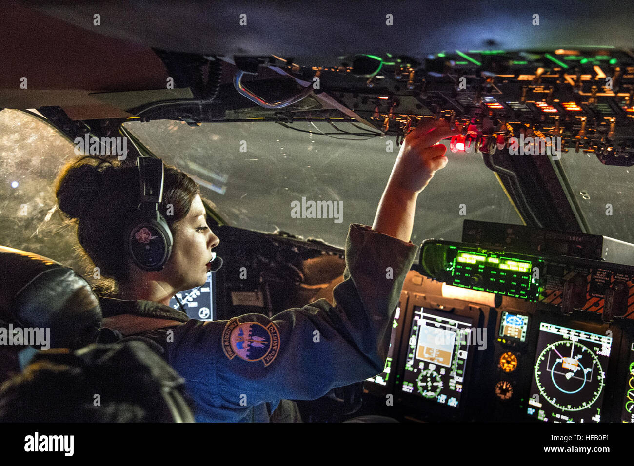 1st Lt. Meaghan Cosand, C-5B Galaxy pilot with the 312th Airlift Squadron, starts engines in preparation for takeoff from Kadena Air Base, Japan, Aug. 15, 2014. She was flying a mobility channel mission, moving high-priority cargo and passengers among air bases in the U.S. Pacific Command area of responsibility.  Lt. Col. Robert Couse-Baker) Stock Photo