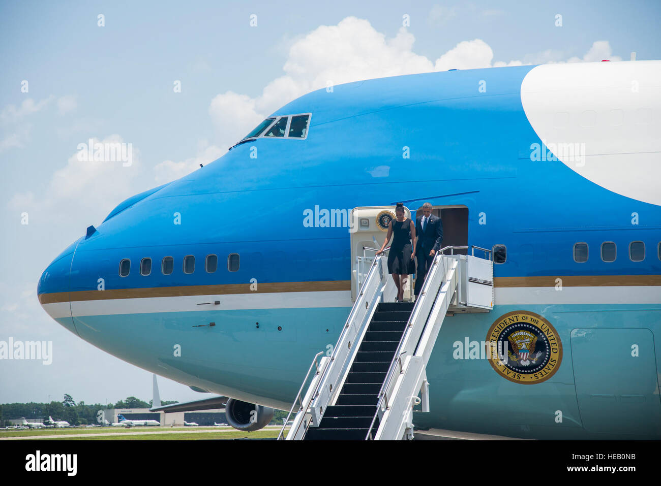 President Barack Obama arrives with first lady Michelle Obama on the flightline June 26, 2015, at Joint Base Charleston, S.C. The president and first lady attended the funeral services of the Rev. Clementa Pinckney at the College of Charleston TD Arena, where President Obama delivered the eulogy. Vice President Joe Biden and Dr. Jill Biden also attended. Pinckney was one of nine people fatally shot June 17, 2015, during a Bible study at Emanuel AME Church in downtown Charleston. Senior Airman George Goslin) Stock Photo