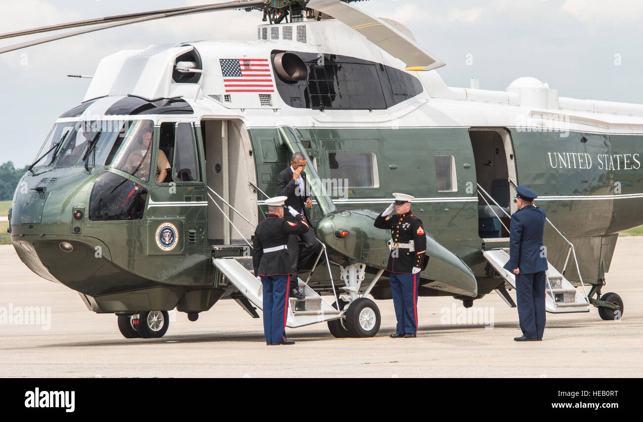 President Barrack Obama steps of Marine One and is greeted by two Marines and Col. J.C. Millard, 89th Airlift Wing commander, at Joint Base Andrews, Md., July 15, 2015. Obama departed Andrews aboard an 89th AW C-32A, call sign ‘Air Force One.’  Senior Master Sgt. Kevin Wallace/) Stock Photo