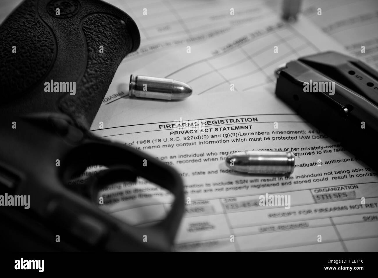a-9-mm-pistol-and-ammunition-sit-on-top-of-an-af-form-1314-firearms