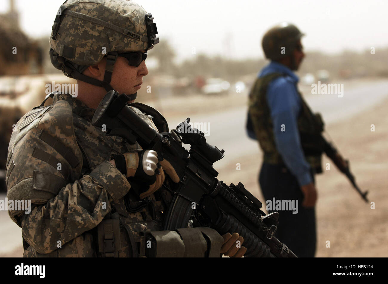 U.S. Army 2nd Lt. Stacy Bixler, a platoon leader from 411th Military Police Company, 716th Military Police Battalion, 101st Airborne Division, provides roadside security with Iraqi police during a dismounted patrol through Meshahdah, Iraq, on April 8, 2008. Tech. Sgt. William Greer) Stock Photo