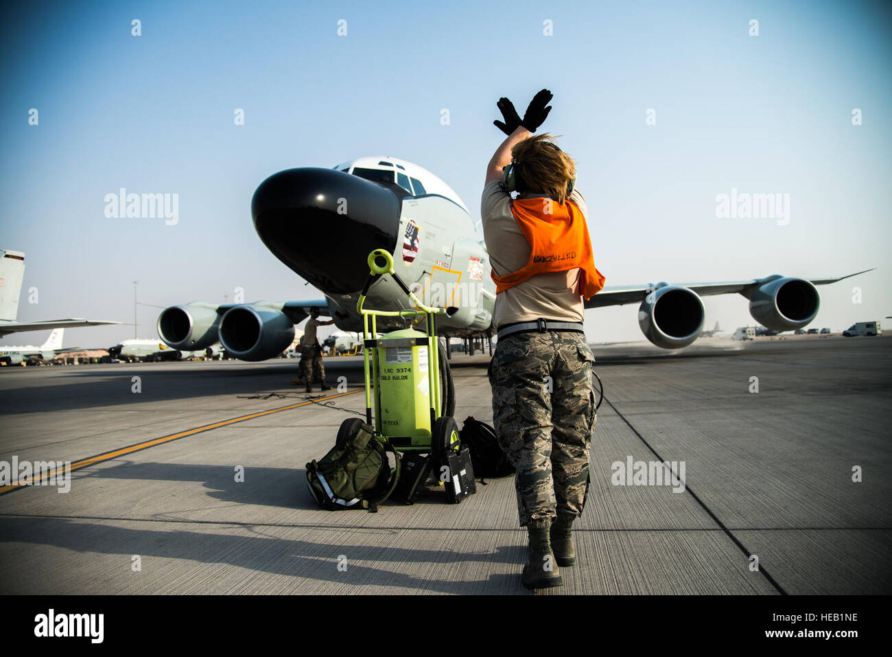A U.S. Air Force Airman marshals an RC135 Rivet Joint surveillance