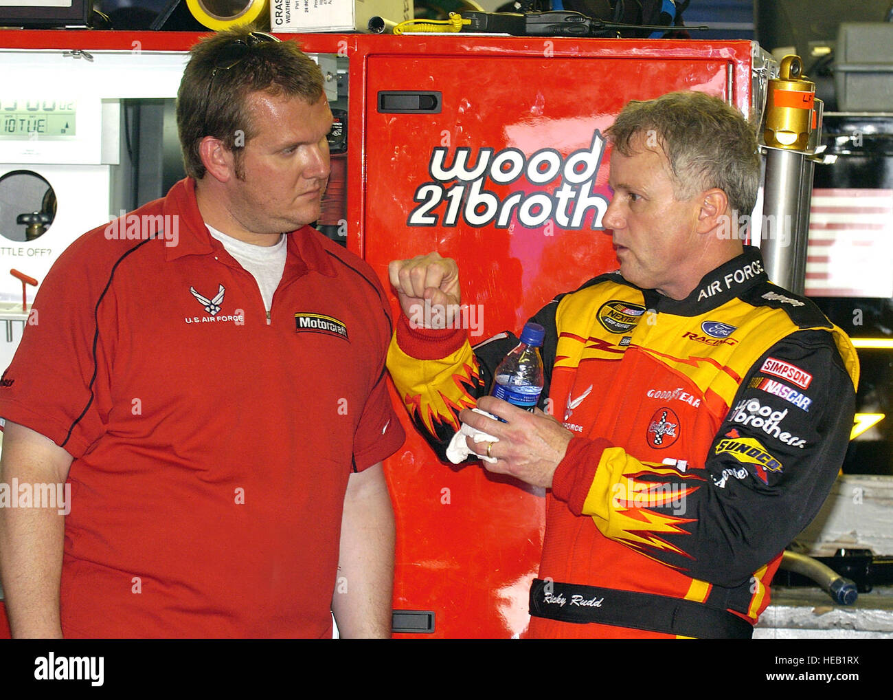 DAYTONA MOTOR SPEEDWAY, Fla. -- Ricky Rudd, driver of the Air Force-sponsored Wood Brothers Racing No. 21 Ford Taurus goes over some car-handling details with his crew chief, Ben Leslie, following a practice session at the speedway Feb. 11.  They are preparing for the Daytona 500 race, which will be held here Feb. 15.   Larry McTighe) Stock Photo