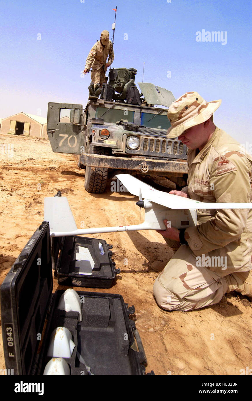 050621-F-9712C-007  Army Cpl. Jerry Rogers assembles a RQ-11 Raven unmanned aerial vehicle in order to conduct aerial tactical reconnaissance of insurgents in Taji, Iraq, on June 21, 2005.  The Raven has video cameras located in the nose cone and can relay live video back to the operator in real-time.  Rogers is attached to the Scout Platoon, 1st Battalion, 13th Armor Regiment, 3rd Brigade, 1st Armored Division.   Tech. Sgt. Russell E. Cooley IV, U.S. Air Force.  (Released) Stock Photo
