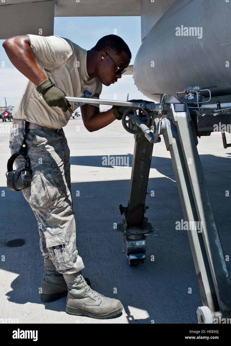 Senior Airman Quenton Richardson, 159th Maintenance Squadron crew chief, Louisiana Air National Guard, removes an external fuel tank on an F-15 Eagle during Red Flag 15-3 at Nellis Air Force Base, Nev., July 14, 2015. Crew chiefs are responsible for overseeing the day-to-day maintenance of aircraft including diagnosing malfunctions and replacing components to ensure the aircraft functions properly.  Airman 1st Class Jake Carter) Stock Photo