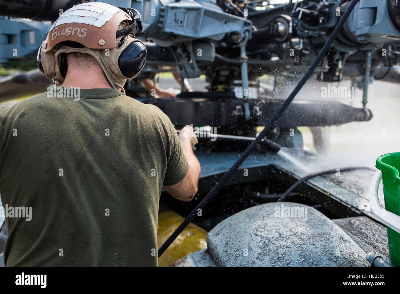 Cpl. Mike Montgomery, a helicopter power plant mechanic with the Special Purpose Marine Air-Ground Task Force-Southern Command and a Walnut, Miss., native, power-washes dirt and grease from the outside of a CH-53E Super Stallion during the thorough cleaning process, known as desnailing, to prepare the aircraft for redeployment at Soto Cano Air Base, Honduras, Oct. 27, 2015. SPMAGTF-SC is a temporary deployment of Marines and sailors throughout Honduras, El Salvador, Guatemala, and Belize with a focus on building and maintaining partnership capacity with each country through shared values, chal Stock Photo