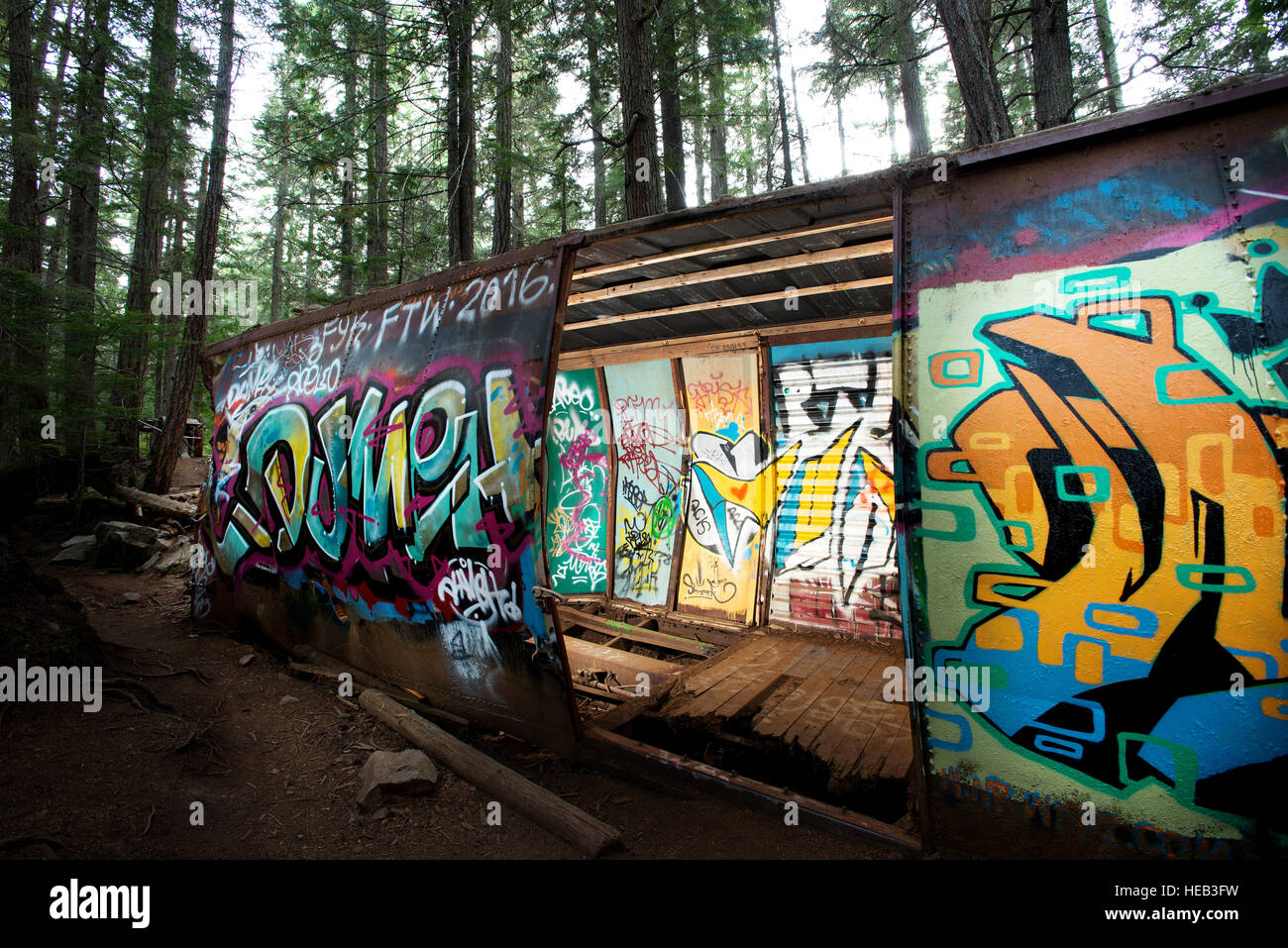The Train Wreck trail.  The wrecked box cars left over from a 1950's PGE railway derailment, now a popular spot for local graffiti artists. Stock Photo
