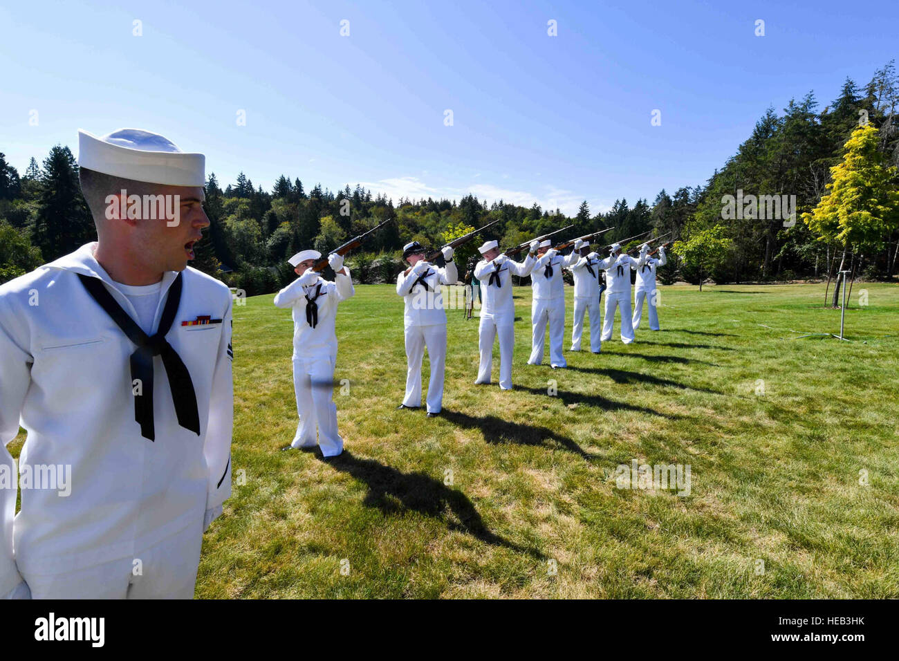 160829-N-EC099-104 BREMERTON, Wash. (Aug. 29, 2016) – Machinist's Mate 2nd Class David Gorey, assigned to Naval Base Kitsap, leads the 21-gun salute for the remains of World War II veteran Lt. Julian Jordan. Jordan was 37 years old when the attack on Pearl Harbor took place and he was indentified with the use of DNA profiling after his body was exhumed from the Nevada-class battleship USS Oklahoma (BB 37). The funeral took place at the Lewis Funeral Chapel in Bremerton, Washington, 75 years after the attack.  Mass Communication Specialist 3rd Class Charles D. Gaddis IV Stock Photo