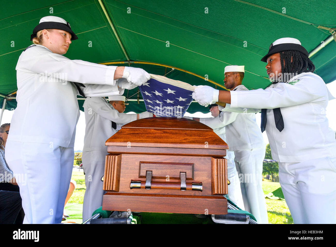 160829-N-EC099-133 BREMERTON, Wash. (Aug. 29, 2016) – Sailors assigned to Naval Base Kitsap fold the National Ensign over the remains of World War II  veteran Lt. Julian Jordan. Jordan was 37 years old when the attack on Pearl Harbor took place and he was indentified with the use of DNA profiling after his body was exhumed from the Nevada-class battleship USS Oklahoma (BB 37). The funeral took place at the Lewis Funeral Chapel in Bremerton, Washington, 75 years after the attack.  Mass Communication Specialist 3rd Class Charles D. Gaddis IV Stock Photo