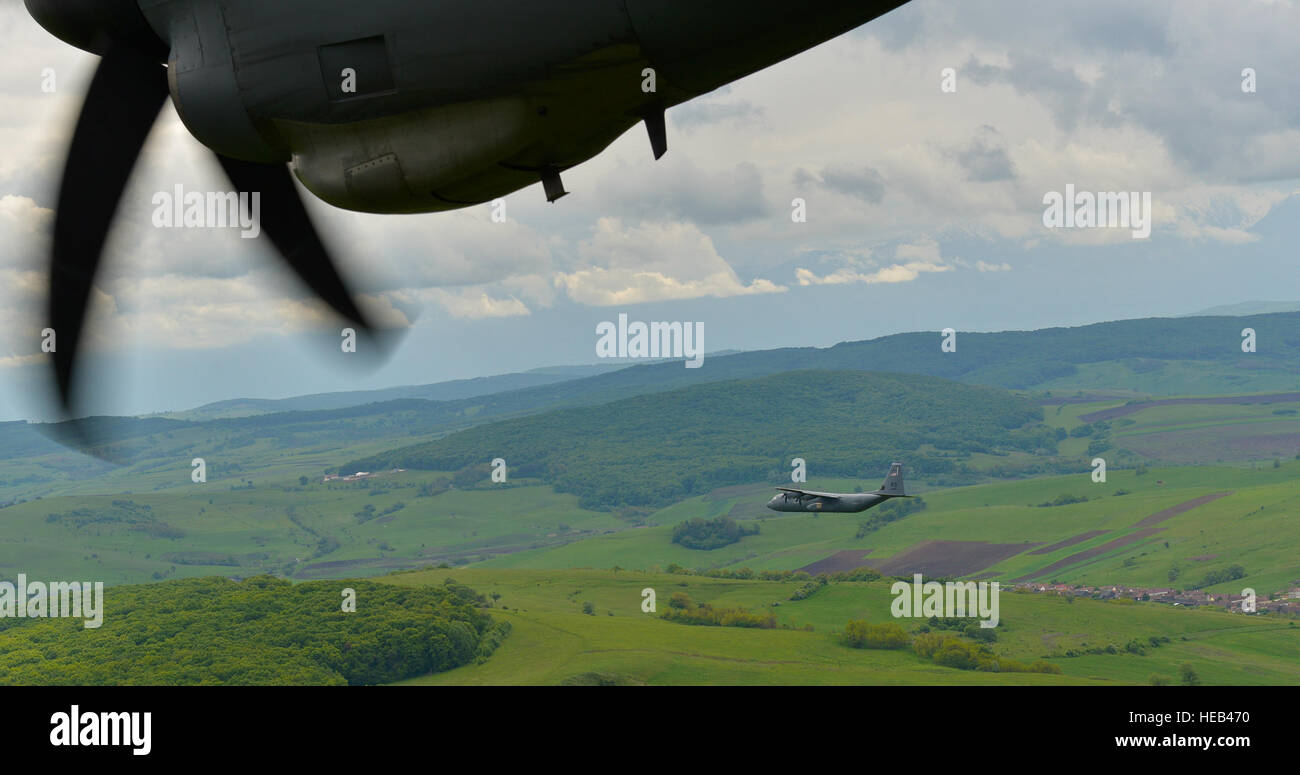 A C-130J Super Hercules from the 37th Airlift Squadron flies over Romania during Exercise Carpathian Spring May 13, 2016. The 37th AS, Ramstein Air Base, Germany, began participating in off-station training deployments with Romania as early as 1996, allowing the U.S. Air Force to work with NATO allies to develop and improve ready air forces capable of maintaining regional security. Stock Photo