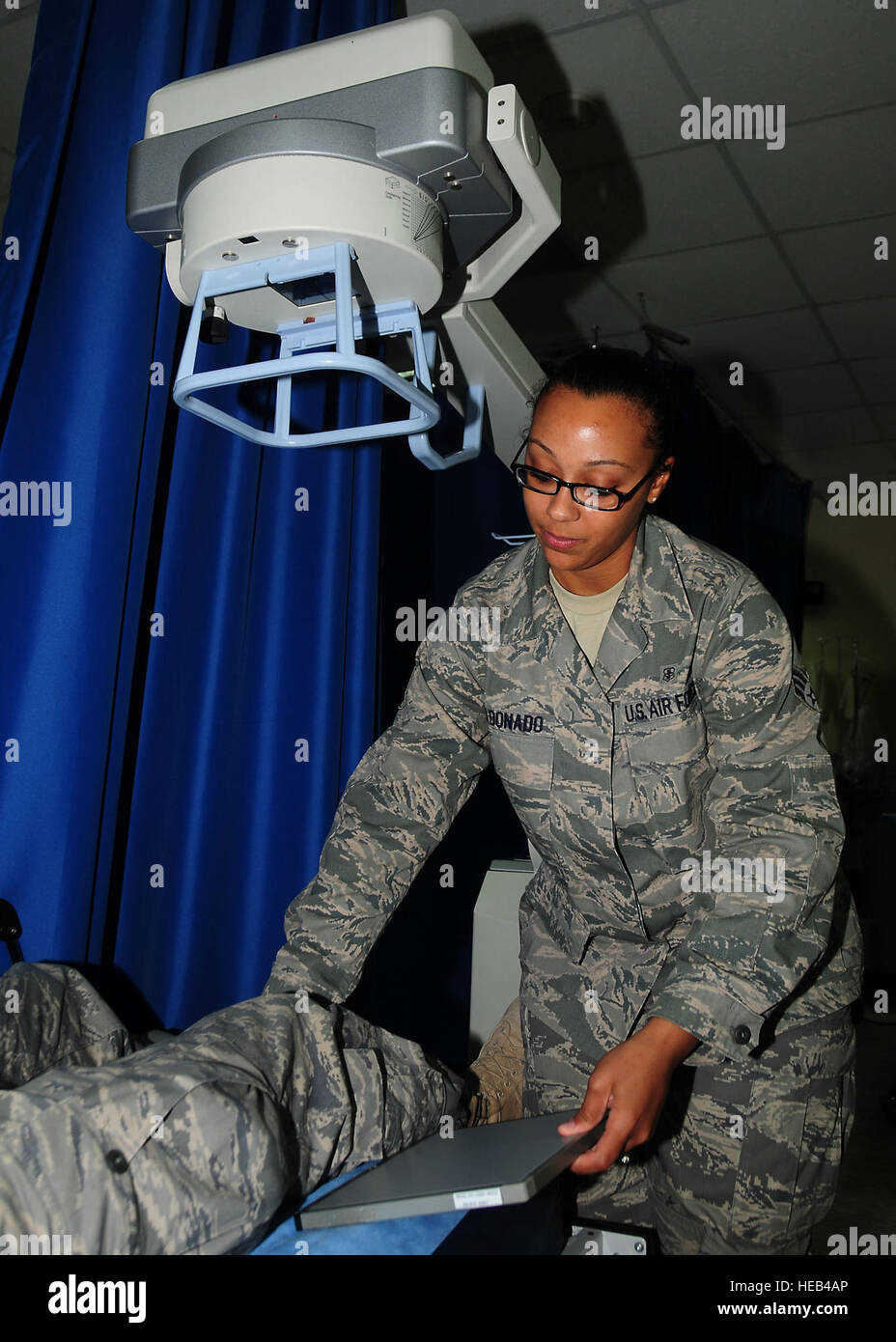SOUTHWEST ASIA -- Senior Airman Ashli Maldonado, 386th Expeditionary Medical Support x-ray technician, prepares a patient for a knee x-ray at an undisclosed location in Southwest Asia Oct. 27, 2009.  Airman Maldonado is deployed from the 81st Medical Operations Squadron, Keesler Air Force Base, Miss., and hails from Colorado Springs, Colo.  Tech. Sgt. Tony Tolley) Stock Photo