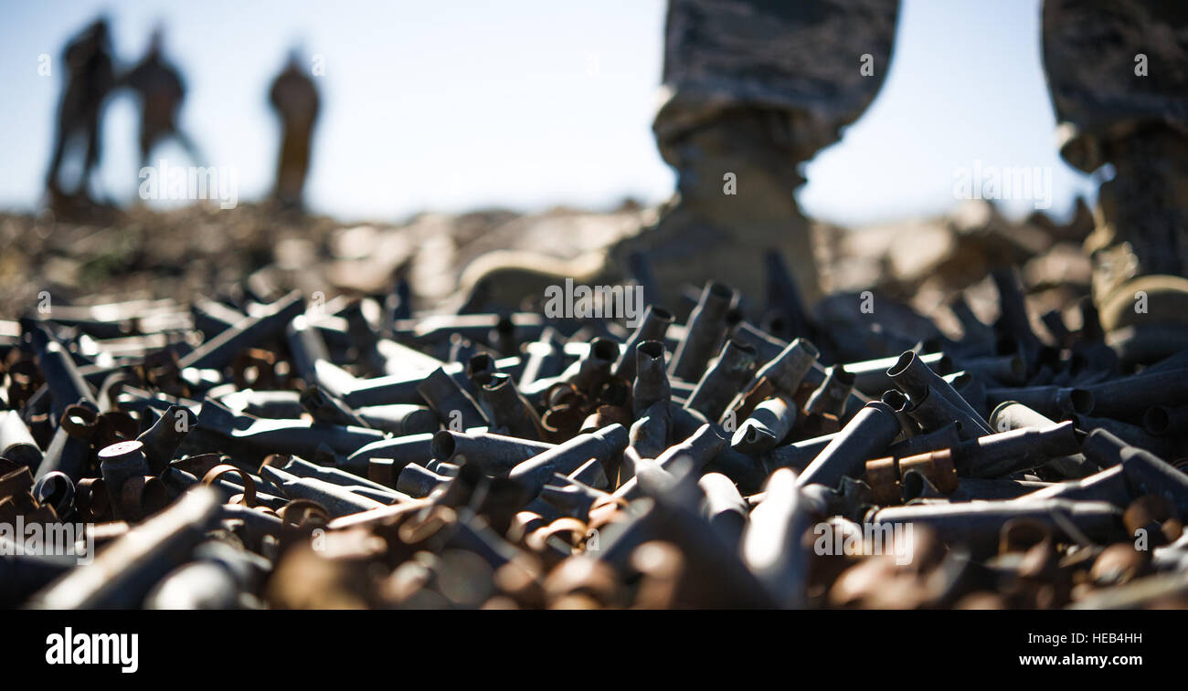 U.S. Air Force Tech. Sgt. Joselito Aribuabo, 3rd Combat Camera, stands near a pile of discarded .50-caliber bullet casings during Integrated Training Exercise 2-16 at Marine Corps Air Ground Combat Center, Twentynine Palms, Calif., Jan. 28, 2016. MCAGCC conducts relevant live-fire combined arms, urban operations, and joint/coalition level integration training that promote operational forces' readiness.  Senior Airman Steven A. Ortiz Stock Photo