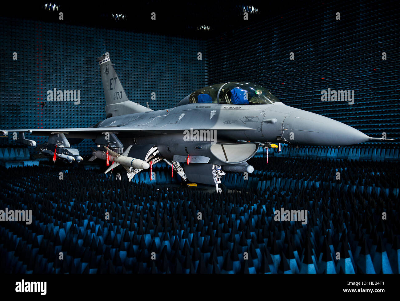 A 40th Flight Test Squadron F-16 Fighting Falcon sits in the anechoic chamber after completion of the initial round of testing simulations on the new M-7 software upgrade Oct. 30, 2014, at Eglin Air Force Base, Fla. The M-7 software package will provide multiple advanced capabilities to the aircraft. The anechoic chamber is a room designed to stop reflections of either sound or electromagnetic waves. The room is insulated from exterior sources of noise. The room is part of a facility that allows testing of air-to-air and air-to-surface munitions and electronics systems on full-scale aircraft a Stock Photo