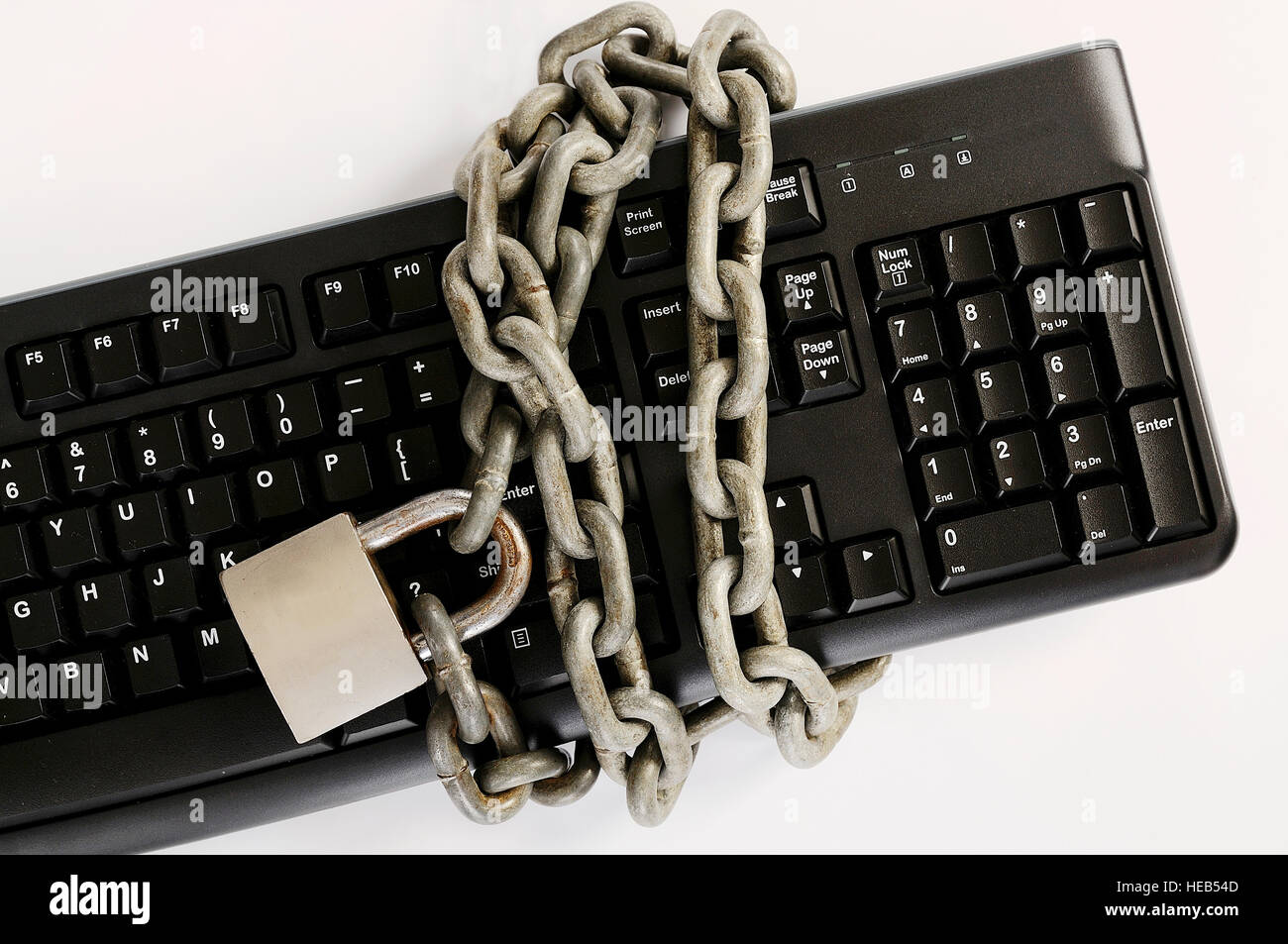 Computer keyboard tied with chain. A computer security concept Stock Photo