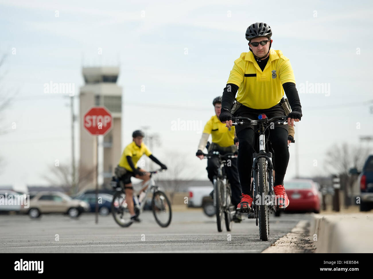 Senior Airman Bernard Pecoraro, 436th Security Forces Squadron response force leader, right, lines his mountain bike up next to a sidewalk March 19, 2015, at Dover Air Force Base, Del. Pecoraro and other bike patrol members practiced riding techniques for properly ascending from and descending to street level from and to curbs; day and night riding; negotiating stairways; and bicycle mounting and dismounting techniques. Roland Balik) Stock Photo