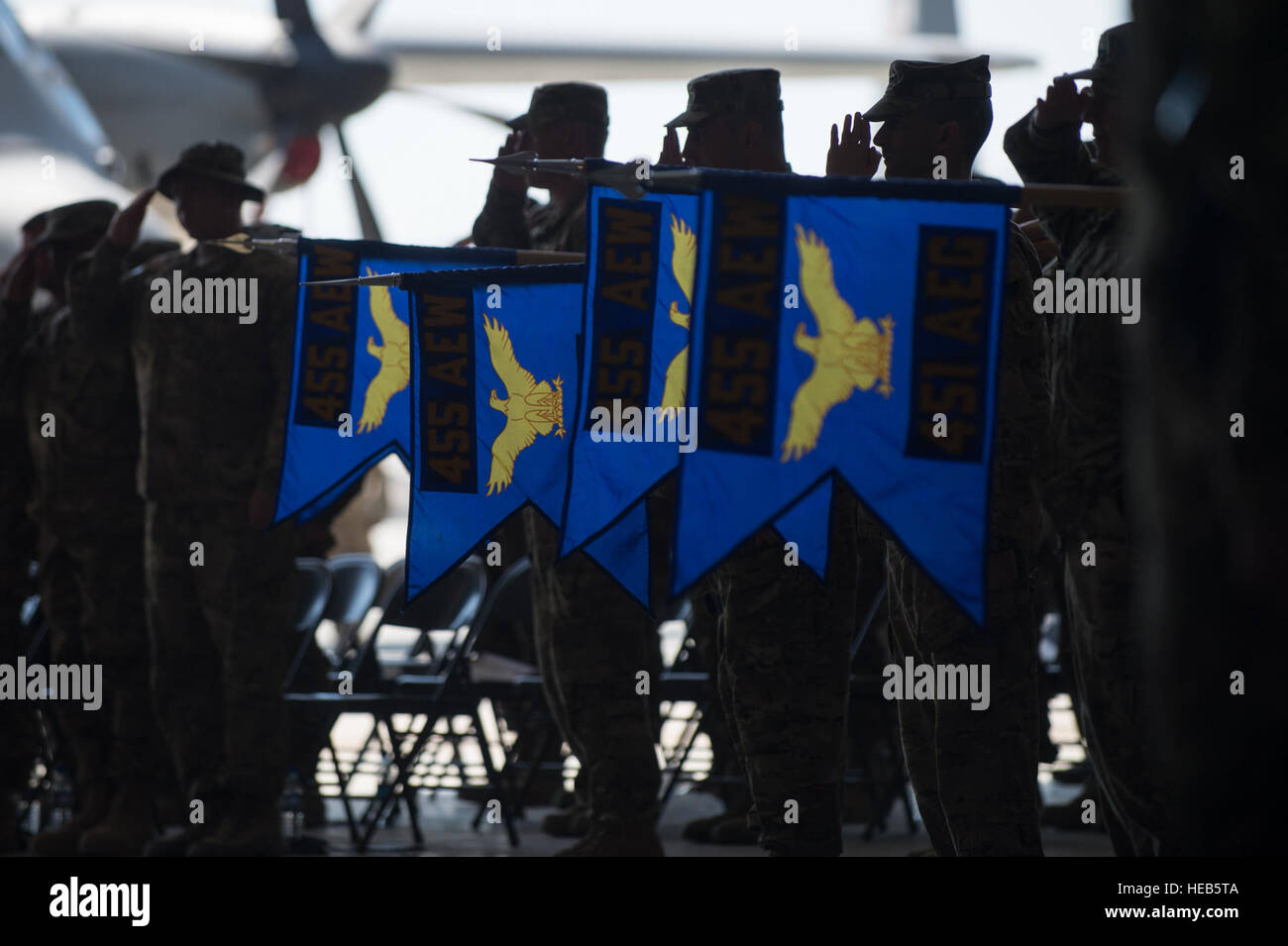 U.S. Airmen assigned to the 455th Air Expeditionary Wing lower the group guidons during the national anthem at the 455th AEW change of command ceremony at Bagram Air Field, Afghanistan, July 1, 2015. During the ceremony Kelly relinquished command of the 455th AEW to Brig. Gen. Dave Julazadeh.   Tech. Sgt. Joseph Swafford Stock Photo
