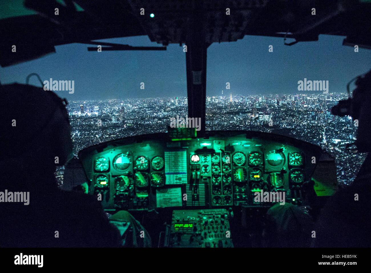Capt. Jonathan Bonilla and 1st Lt. Vicente Vasquez, 459th Airlift Squadron UH-1N Huey pilots, fly over Tokyo after completing night training April 25, 2016. The 459th AS frequently trains on a multitude of scenarios in preparation for potential real-world contingencies and operations. Yasuo Osakabe) Stock Photo