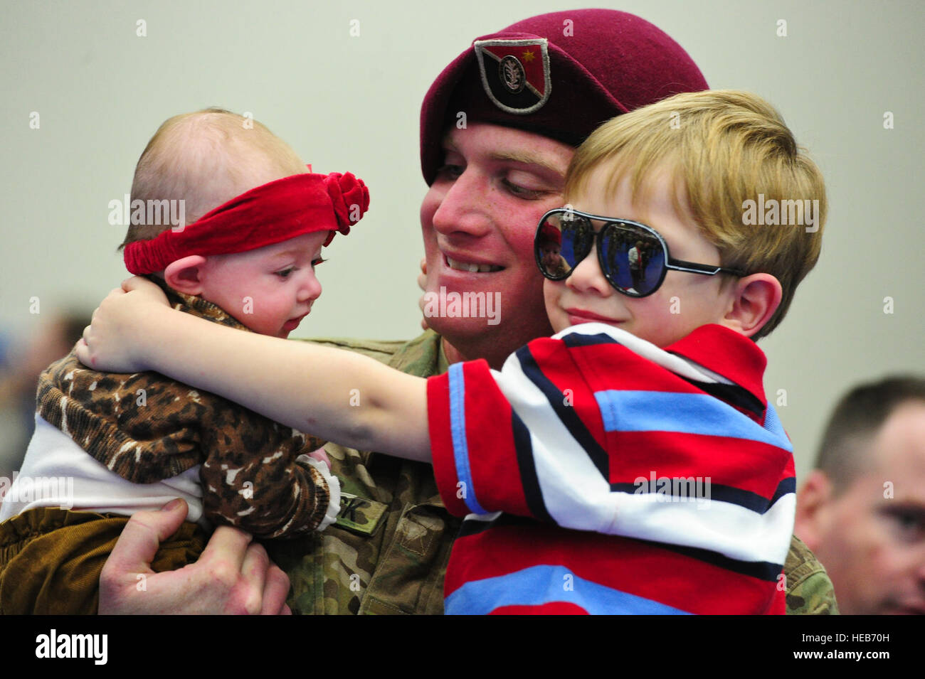 Staff Sgt. Brian Comstock, a native of Elmira, N.Y., holds his son ...