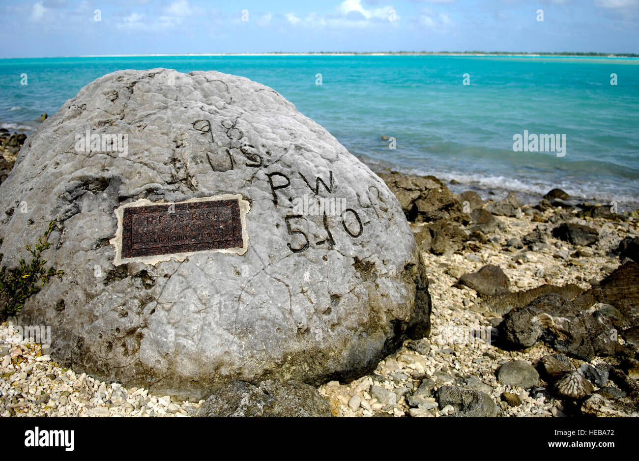 A memorial to prisoners of war is seen Jan. 12 on Wake Island. The '98 Rock' is a memorial for the 98 U.S. civilian contract POWs who were forced by their Japanese captors to rebuild the airstrip as slave labor, then blind-folded and killed by machine gun Oct. 5, 1943. An unidentified prisoner escaped, and chiseled '98 US PW 5-10-43' on a large coral rock near their mass grave, on Wilkes Island at the edge of the lagoon. The prisoner was recaptured and beheaded by the Japanese admiral, who was later convicted and executed for war crimes. Tech. Sgt. Shane A. Cuomo) Stock Photo