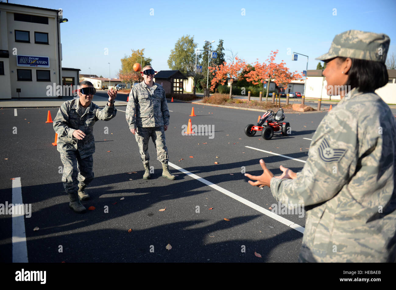 SPANGDAHLEM AIR BASE, Germany ???U.S. Air Force Col. Dave Julazadeh, left, 52nd Fighter Wing commander from Peoria, Ill., and Col. Joseph McFall, 52nd Fighter Wing vice commander from Maple Valley, Wash., catch and throw foam balls while wearing drunk-goggles Oct. 22, 2012, outside of the Spangdahlem Skyline Movie Theater during a ???Drunk Busters??? obstacle course event.  The 52nd Medical Operations Squadron Alcohol and Drug Abuse Prevention and Treatment Program received 25 referrals for driving under the influence this year.  The purpose of this course is to aid in preventing alcohol-relat Stock Photo