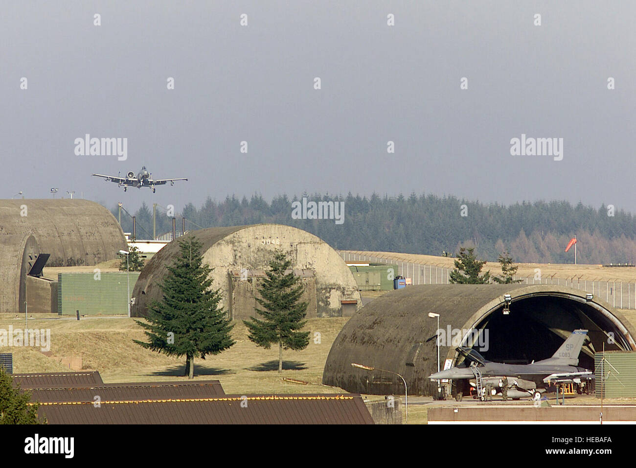 A US Air Force (USAF) A-10 Thunderbolt II aircraft (background) from the 81st Fighter Squadron (FS), 52nd Fighter Wing (FW), flies a familiarization flight down the newly constructed North Atlantic Treaty Organization (NATO) runway at Spangdahlem Air Base, Germany, in preparation for the changes taking effect due to the Rhein-Main Transition Project. A USAF F-16C Fighting Falcon aircraft is visible foreground right. Stock Photo