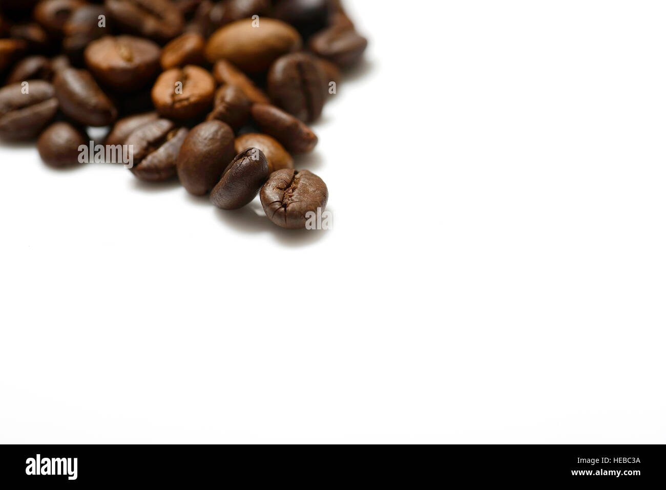 Brown roasted coffee beans isolated on white background Stock Photo - Alamy