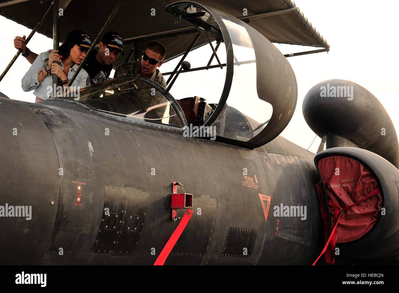 U.S. Air Force Airman 1st Class Charles Hayes, 380th Expeditionary Aircraft Maintenance Squadron U-2 assistant dedicated crew chief, gives a U-2 cockpit tour to American Idol stars Diana Degarmo and Ace Young at an undisclosed location in Southwest Asia Feb. 28, 2013. Degarmo and Young visited the men and women of the 380th Air Expeditionary Wing to express the country's gratitude for their service and sacrifice during the Vice Chairman of the Joint Chiefs of Staff Adm. James A. Winnefeld USO tour. (U.S. Air Force photo by Tech. Sgt. Christina M. Styer/Released) Stock Photo