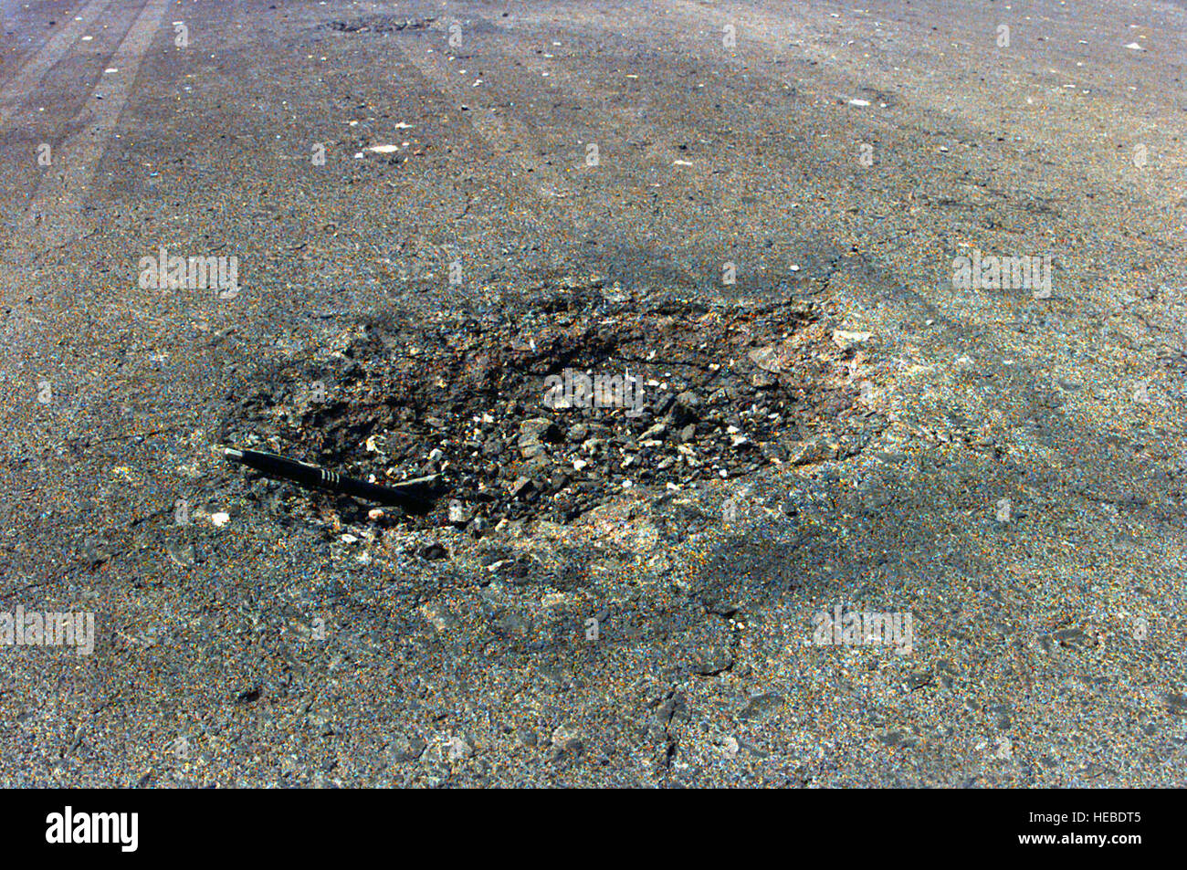 Shown is a close-up of the cluster bomb damage of the runway at 