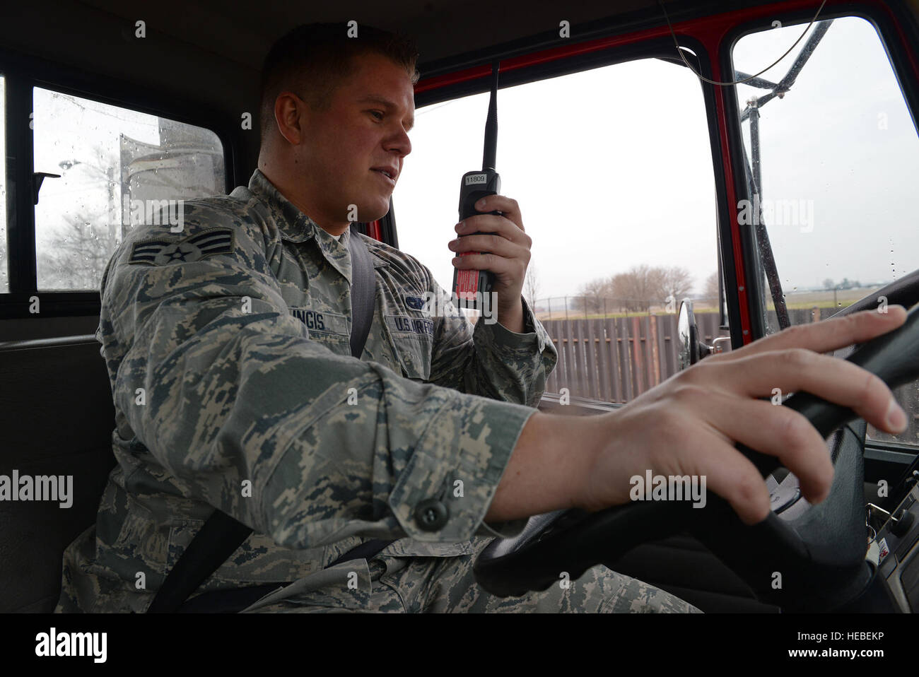 Senior Airman Dainius Milingis, 375th Logistics Readiness Squadron Vehicle Operator, communicates with a fellow vehicle operator in the work yard before driving a flatbed truck, Scott Air Force Base, Ill., March 24, 2015. Milingis serves the base by supplying vehicles to government license holders, ensuring transportation is provided to tour groups and providing government vehicle assistance, such as towing if necessary. (U.S. Air Force photo by Airman 1st Class Erica Crossen) Stock Photo