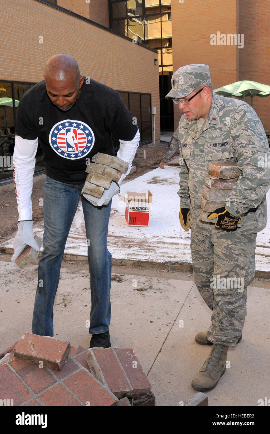Second Lt Matthew Plendl 419th Fighter Wing and Thurl Bailey, retired NBA player with the Utah JAZZ, dispose of old brick at the George E. Wahlen Department of Veterans Affairs Medical Center, Salt Lake City, during a service project, Nov. 6, 2014. In honor of Veterans Day, active duty personnel from military bases around Utah, participated side-by-side with NBA players from the Utah Jazz basketball team, in several service projects at the VA Medical Center, Salt Lake City, Utah. (U.S. Air Force photo by Todd Cromar/Released) Stock Photo