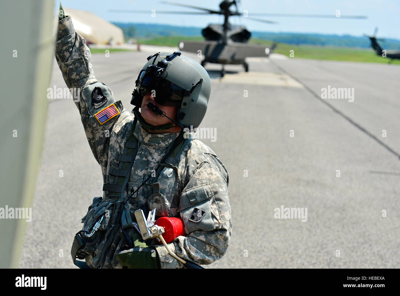 U.S. Army Staff Sgt. Michael Suiters, a flight engineer assigned to Bravo Company, 2-4 General Support Aviation Battalion (GSAB), checks a CH-47F Chinnook before flight during exercise Vibrant Response 14 at Camp Atterbury, Ind., July 22, 2014. Vibrant Response is a Defense Chemical, Biological, Radiological, and Nuclear Response Force (DCRF) training event. The exercise focuses on Department of Defense support of civil authorities in a consequence management role. The DCRF is part of DOD's scalable response capability to assist civilian responders in saving lives, relieving human suffering an Stock Photo