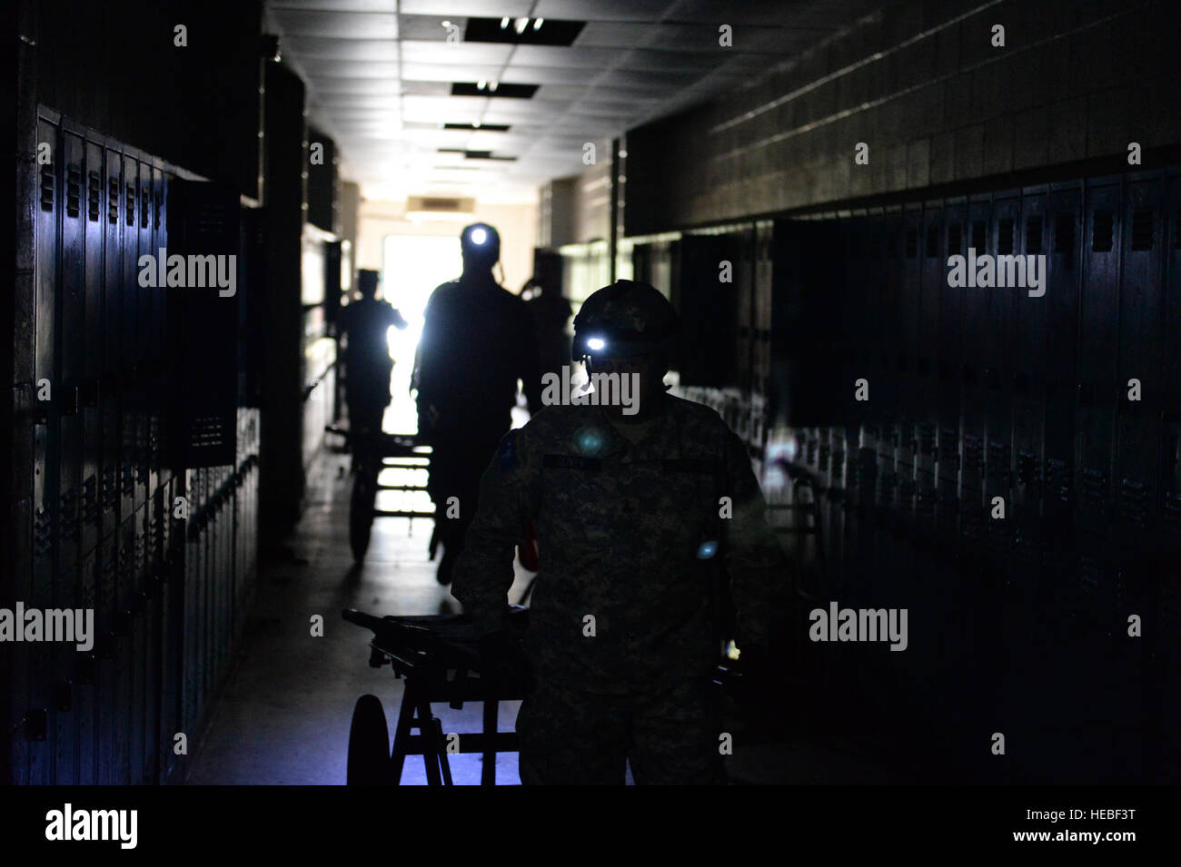 Greenville County search and rescue personnel make their way through the old Woodmont High School in search of simulated victims, March 10, in Greenville, S.C. South Carolina National Guard units worked with local emergency management agencies and first responders during a mass casualty exercise that covered both Greenville and Anderson, S.C., Mar. 10, 2015, as part of Vigilant Guard S.C. 2015. Vigilant Guard S.C. was an eight-day field exercise held March 5-12, that took place at numerous locations across South Carolina and was used as a way for the National Guard and its local and federal pa Stock Photo