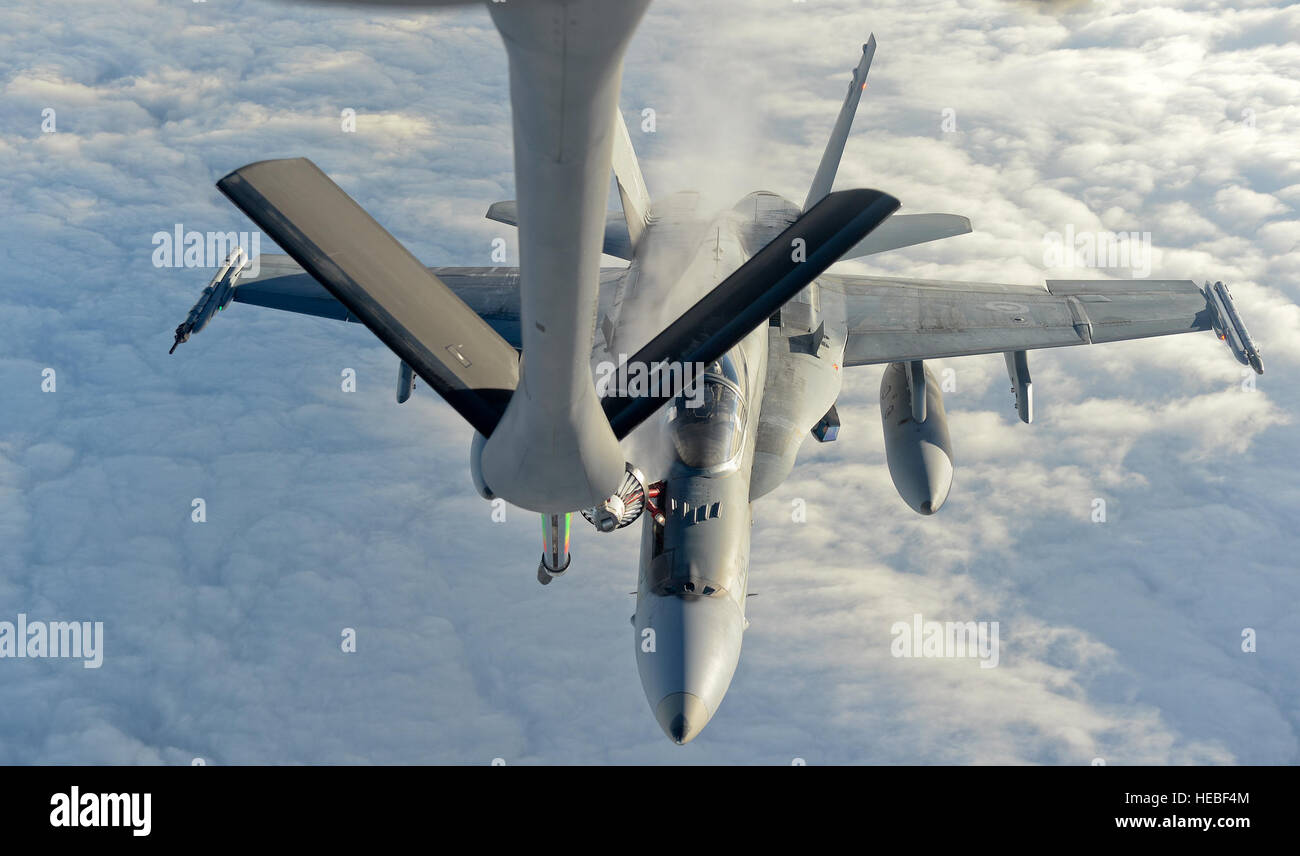A CF-18 Hornet, 425 Tactical Fighter Squadron, is refueled by a KC-135 Stratotanker from McConnell Air Force Base, Kan., during exercise Vigilant Shield 15 at 5 Wing Goose Bay, Newfoundland and Labrador, Oct. 25, 2014. The Vigilant Shield field training exercise is a bi-national NORAD Command exercise which provides realistic training and practice for American and Canadian forces in support of respective national strategy for North America’s defense. NORAD ensures U.S. and Canadian air sovereignty through a network of alert fighters, tankers, airborne early warning aircraft, and ground-based a Stock Photo