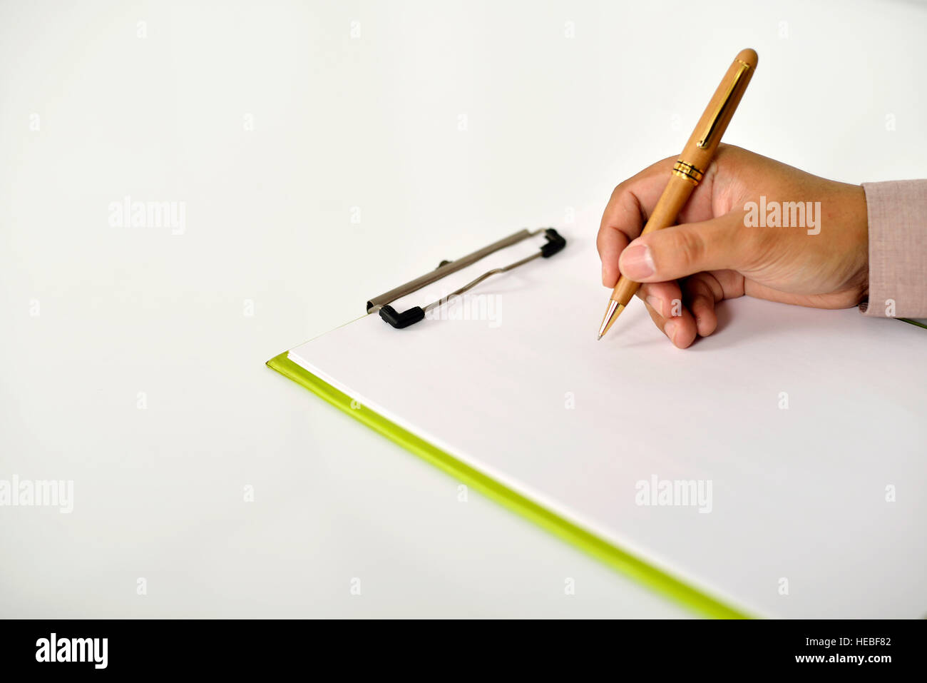 Business man writing something on the clipboard Stock Photo - Alamy