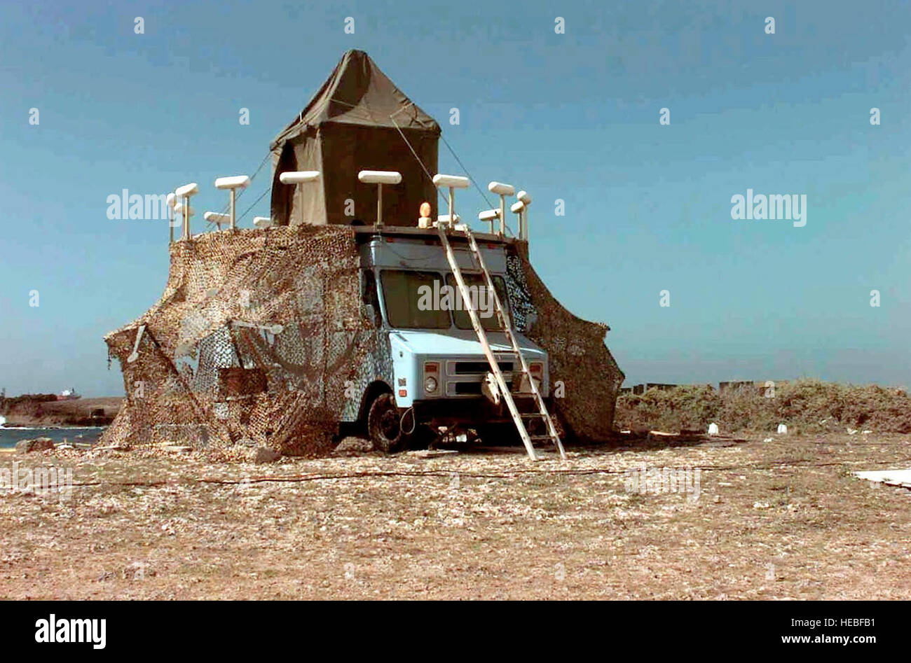 Straight on shot of a Variable Omni Range, Meteorological Navigational Aids System, utilizing an AN/FRN-44 VOR Site Survey Van with a VHF Omni Range Radio.  The site was set up by the 485th Engineering Installation Group, Griffiss, Air Force Base, New York.  The purpose of the vans is to help civilian aircraft navigate into Mogadishu Airport.  This mission is in direct support of Operation Restore Hope. Stock Photo